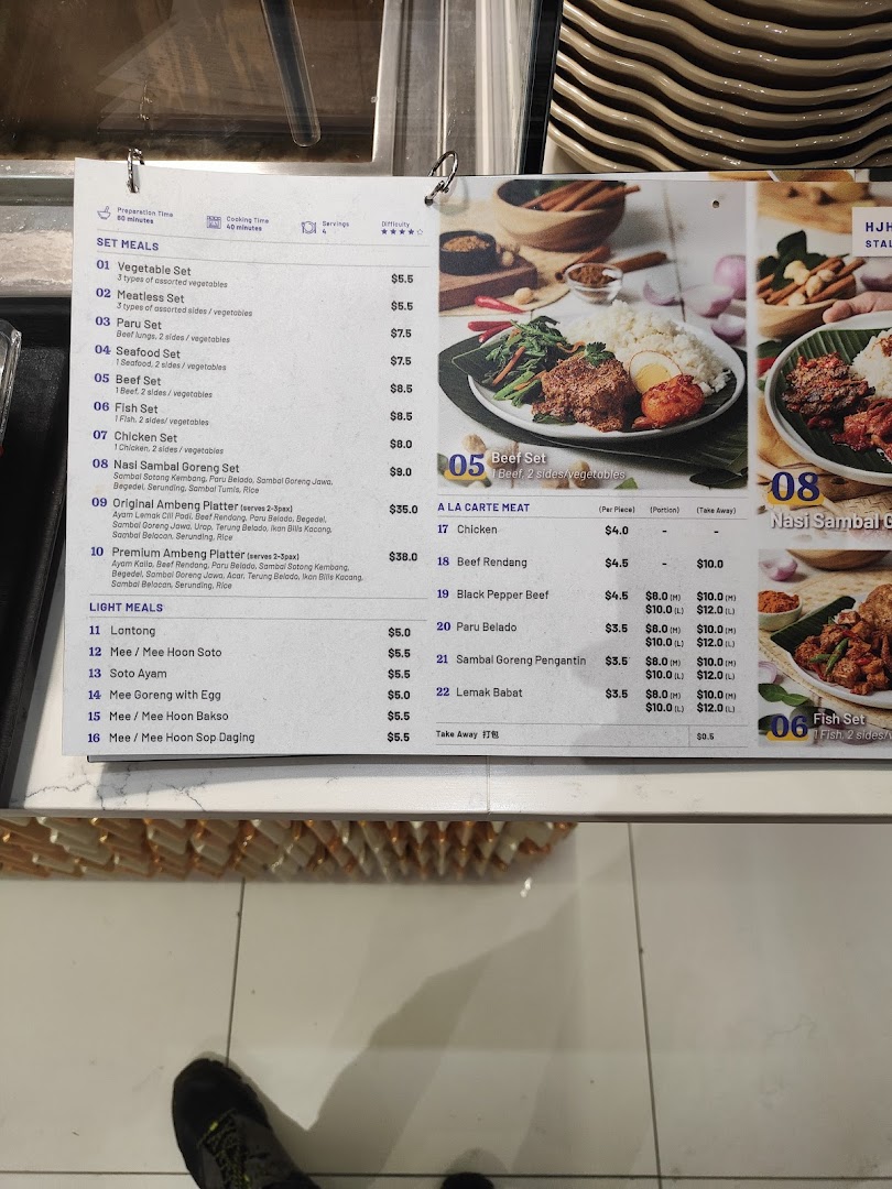 A detailed menu board displaying various Indonesian and Malay set meals, a la carte meats, and light meals with prices.