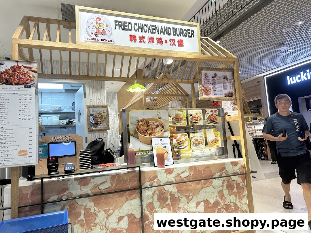A bustling food stall named 'I Like Chicken' offering fried chicken and burgers.