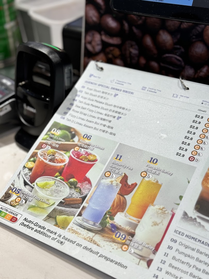 A close-up of a beverage menu displaying various refreshing drinks with prices and Nutri-Grade information.