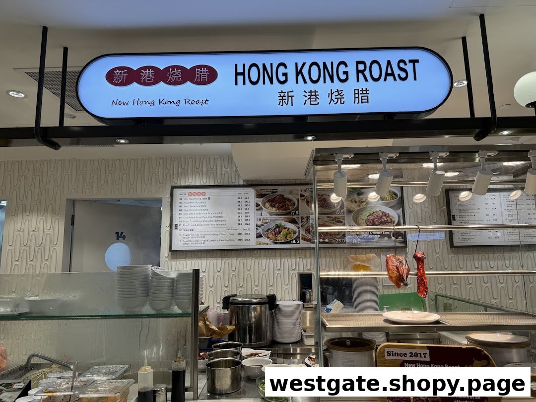 A food stall counter featuring a 'Hong Kong Roast' sign, menu boards, and hanging roasted meats.