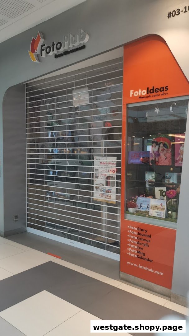 The closed shop front of FotoHub, a photo printing and personalized gift store, featuring its logo and display window.