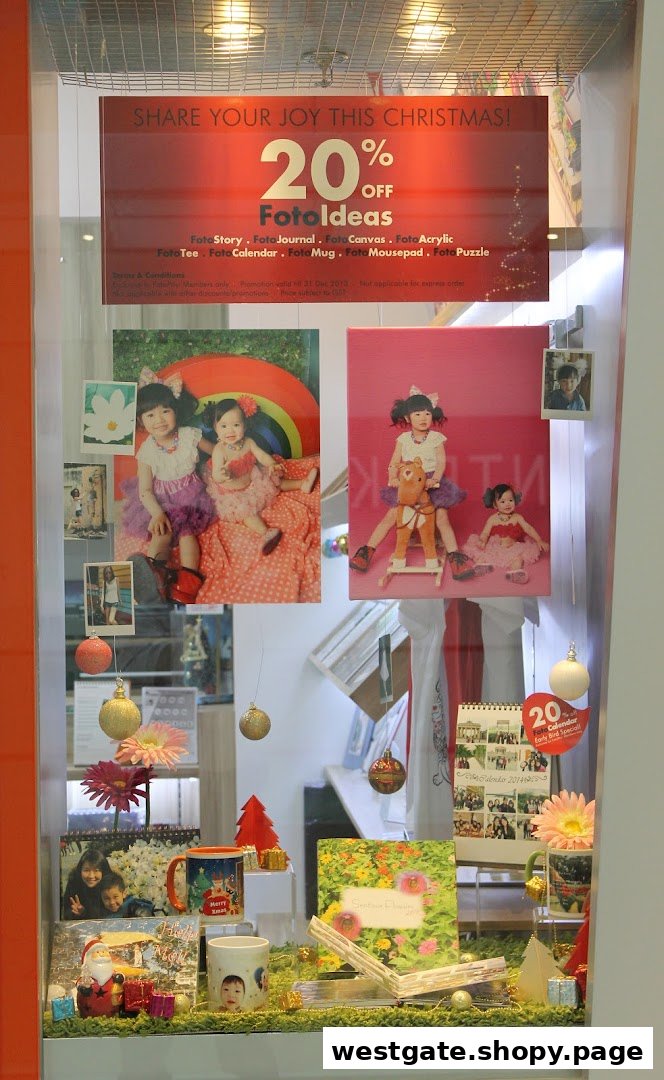 A festive FotoHub shop window display showcasing personalized photo gifts and a Christmas sale.