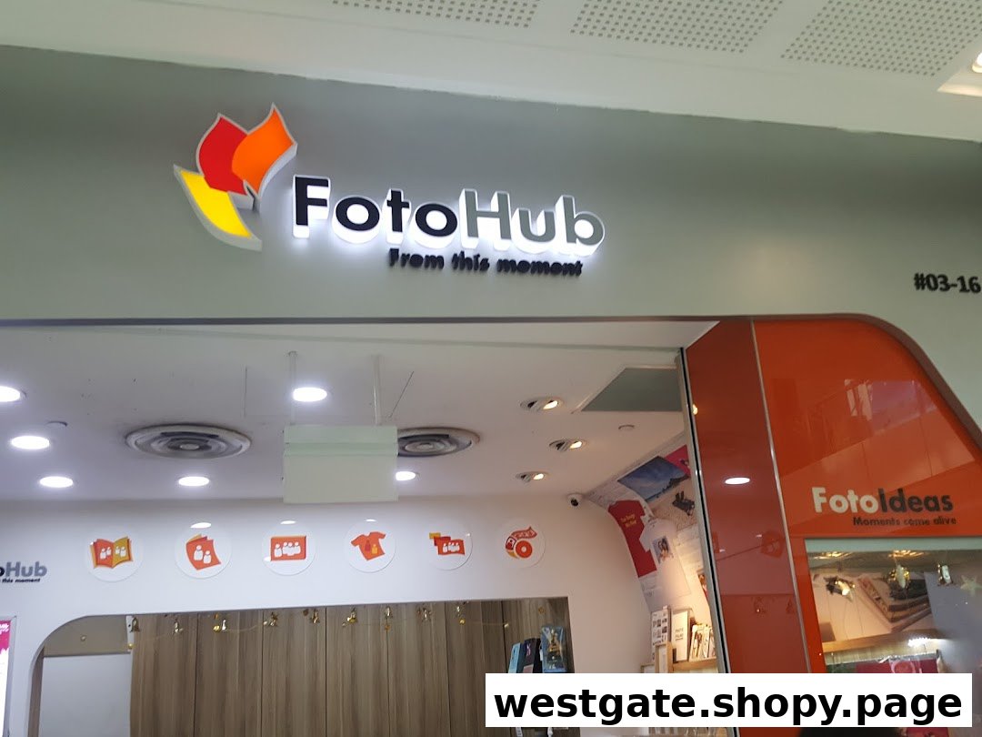 The illuminated shopfront of FotoHub at Westgate, showcasing its logo and entrance.