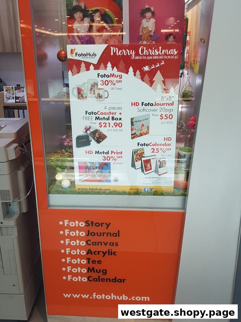 A FotoHub display showcasing personalized photo products and Christmas promotions like FotoMugs, FotoCoasters, and FotoJournals.