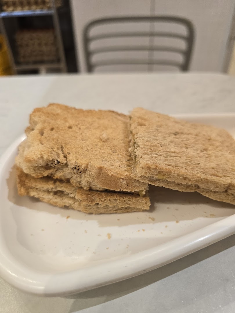 A close-up of golden brown toast slices served on a white plate at Fun Toast.