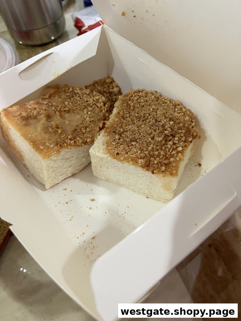 Two slices of Fun Toast's signature peanut butter toast with crushed peanuts in a takeaway box.