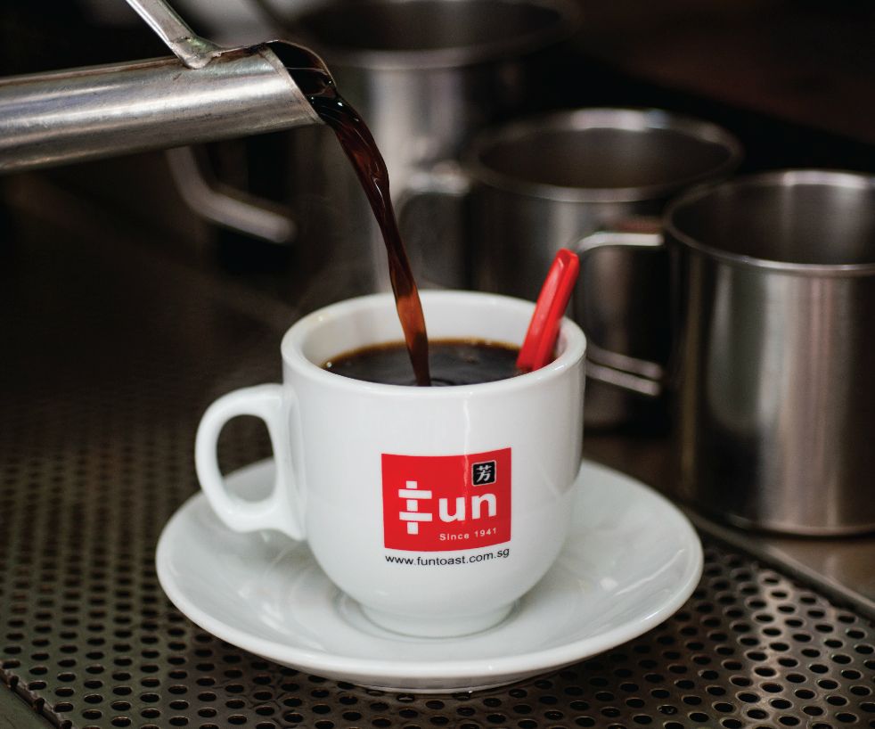 Freshly brewed coffee being poured into a Fun Toast cup, showcasing the brand's beverage.