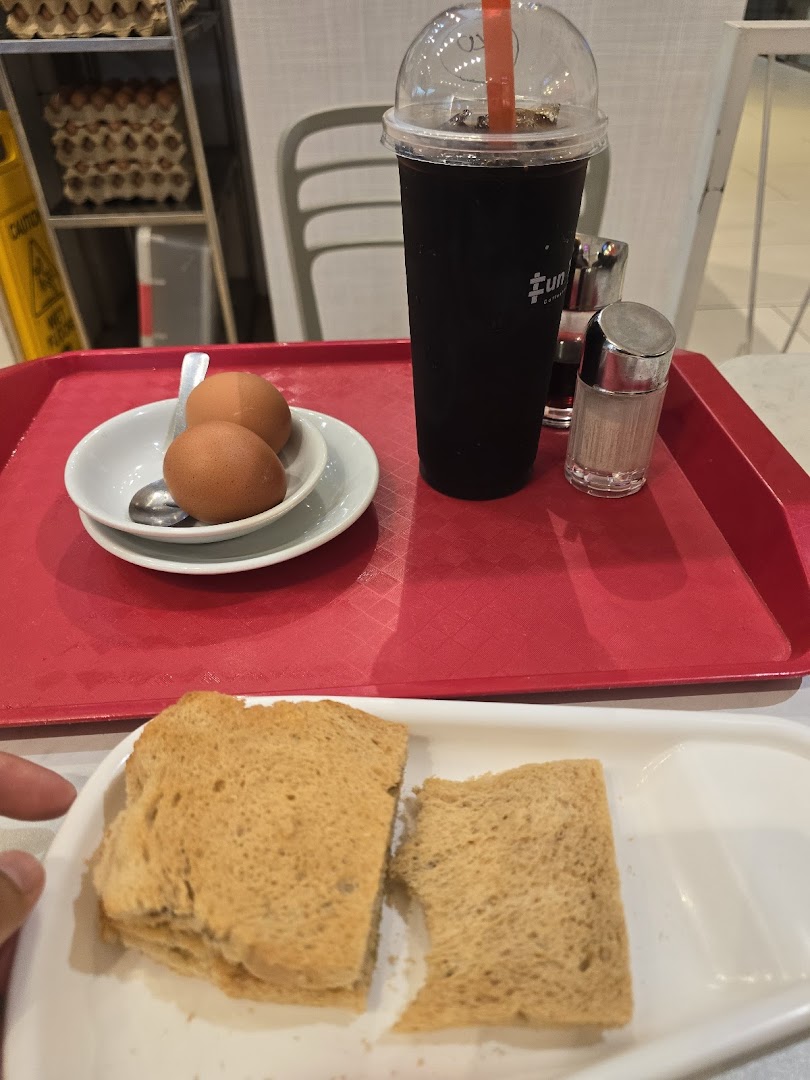 A tray featuring toast, soft-boiled eggs, and an iced beverage from Fun Toast.