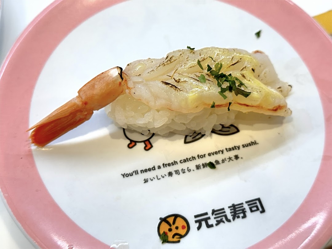 A close-up of a delicious shrimp sushi nigiri served on a branded Genki Sushi plate.