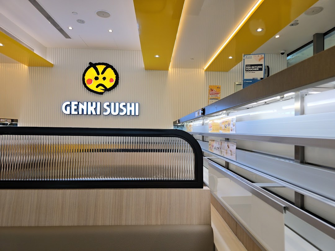 Interior view of Genki Sushi, showcasing its modern design, iconic logo, and the dynamic sushi conveyor belt.