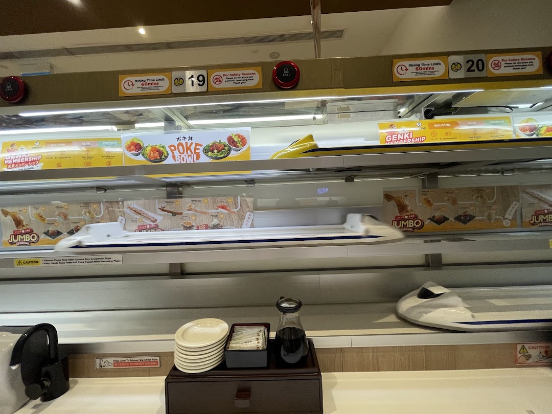 Interior view of Genki Sushi showcasing its unique express food delivery system and dining counter.