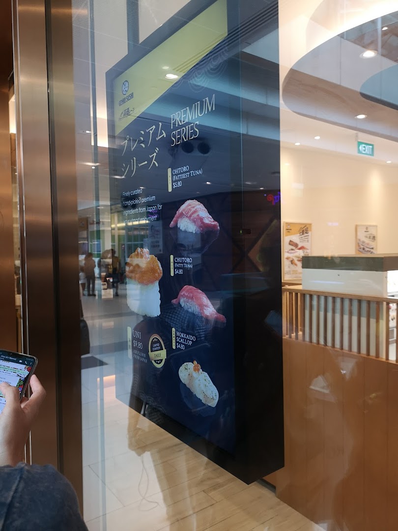 A digital display showcasing Genki Sushi's premium series sushi items with prices and descriptions.