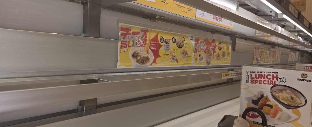Interior view of Genki Sushi featuring its conveyor belt system and promotional food displays.