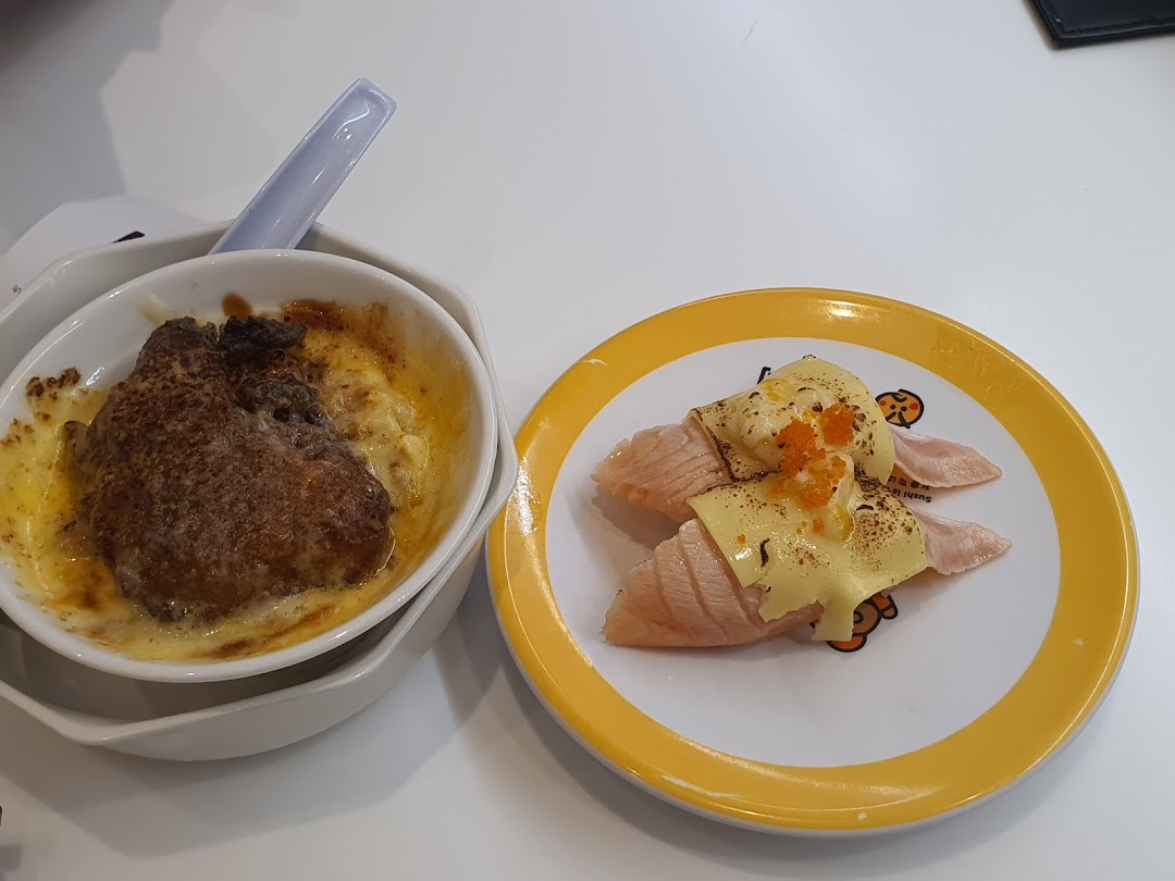 A close-up of two delicious dishes: baked chicken gratin and torched salmon sushi with cheese and roe.