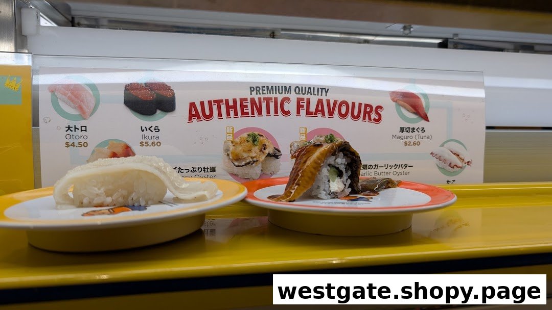 Fresh sushi dishes on a conveyor belt with a promotional display in the background.