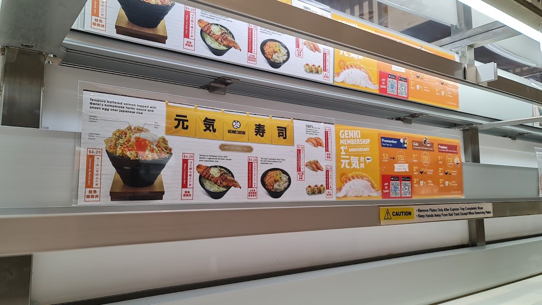 A display board showcasing Genki Sushi's menu items, prices, and membership promotions.