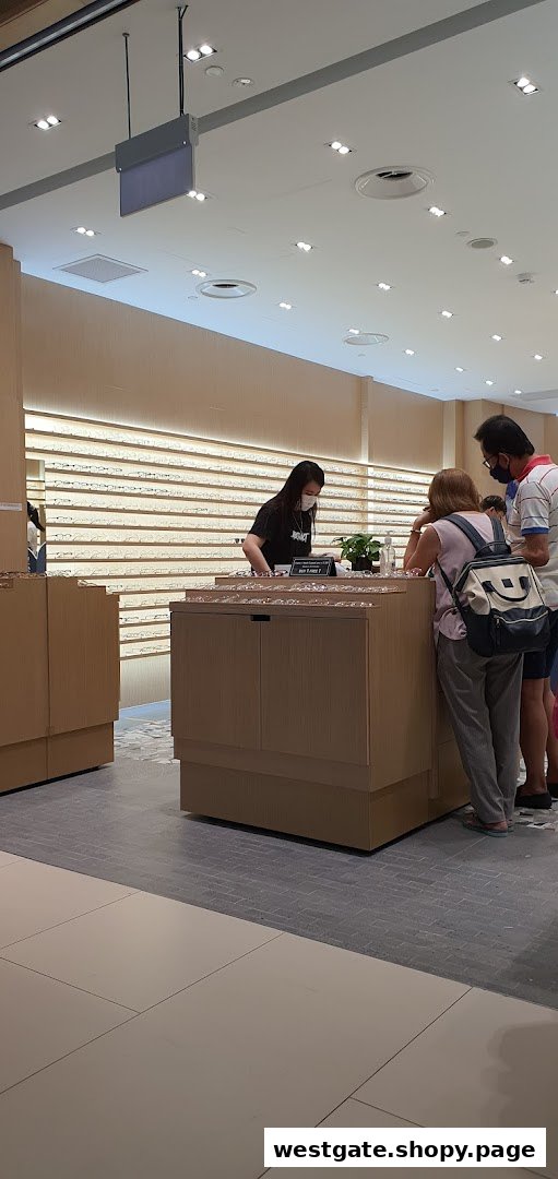 Customers browse eyeglasses and optical frames at the Glimpse retail store, assisted by staff.