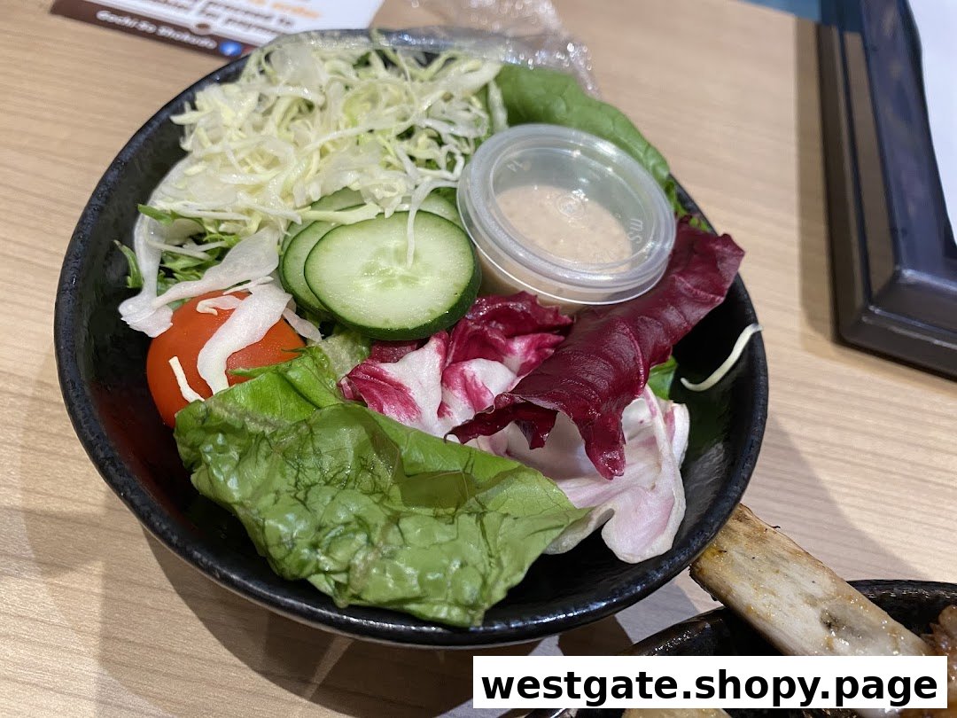 A vibrant garden salad featuring fresh greens, sliced cucumber, cherry tomato, and dressing in a black bowl.
