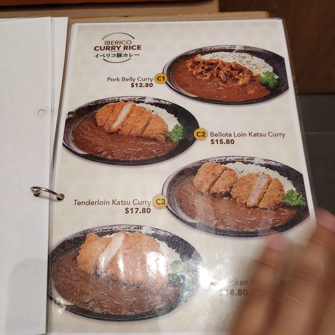 A menu page showcasing various Iberico pork and chicken curry rice dishes with prices.