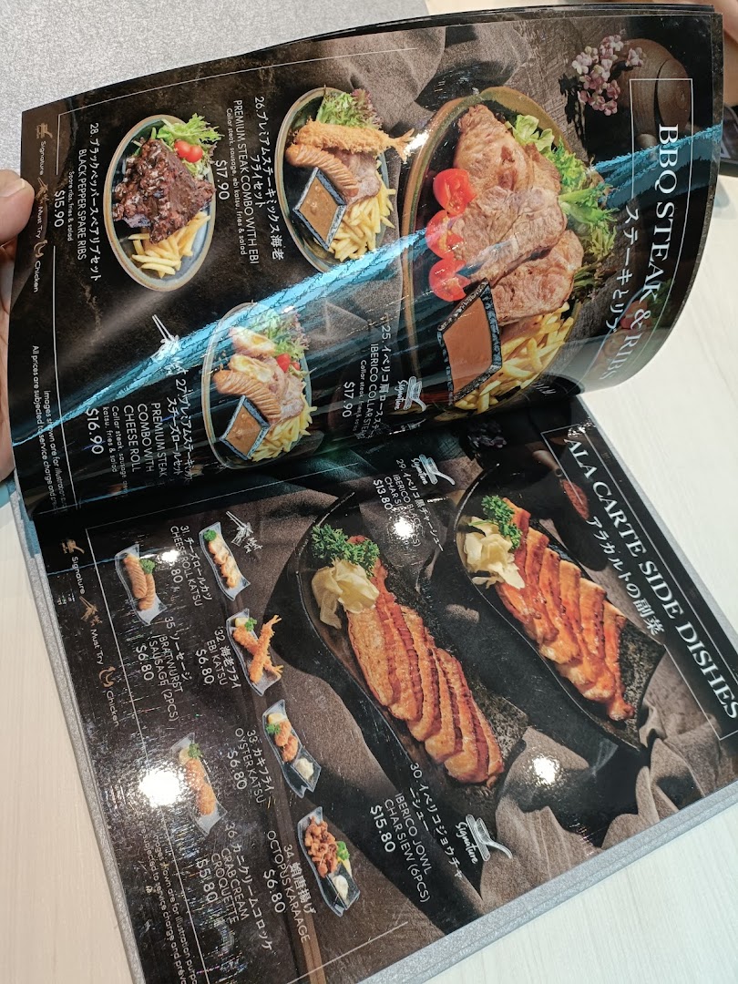 A close-up view of a restaurant menu displaying various steak, ribs, and side dishes.