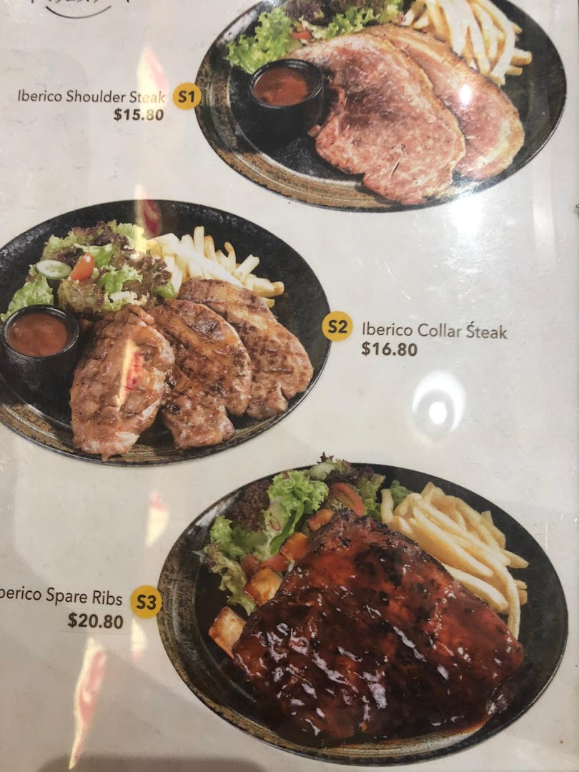 A menu displaying various Iberico pork dishes with their prices and accompanying sides.