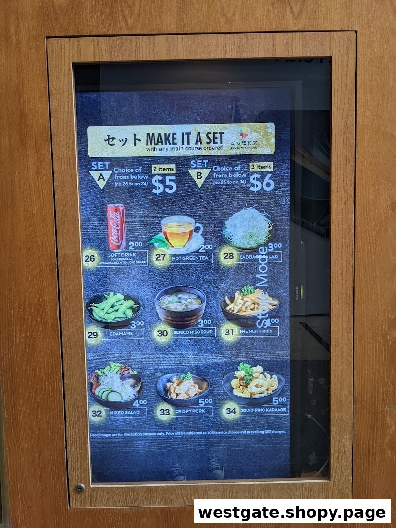 A digital menu board displaying set meal options and various side dishes with prices.