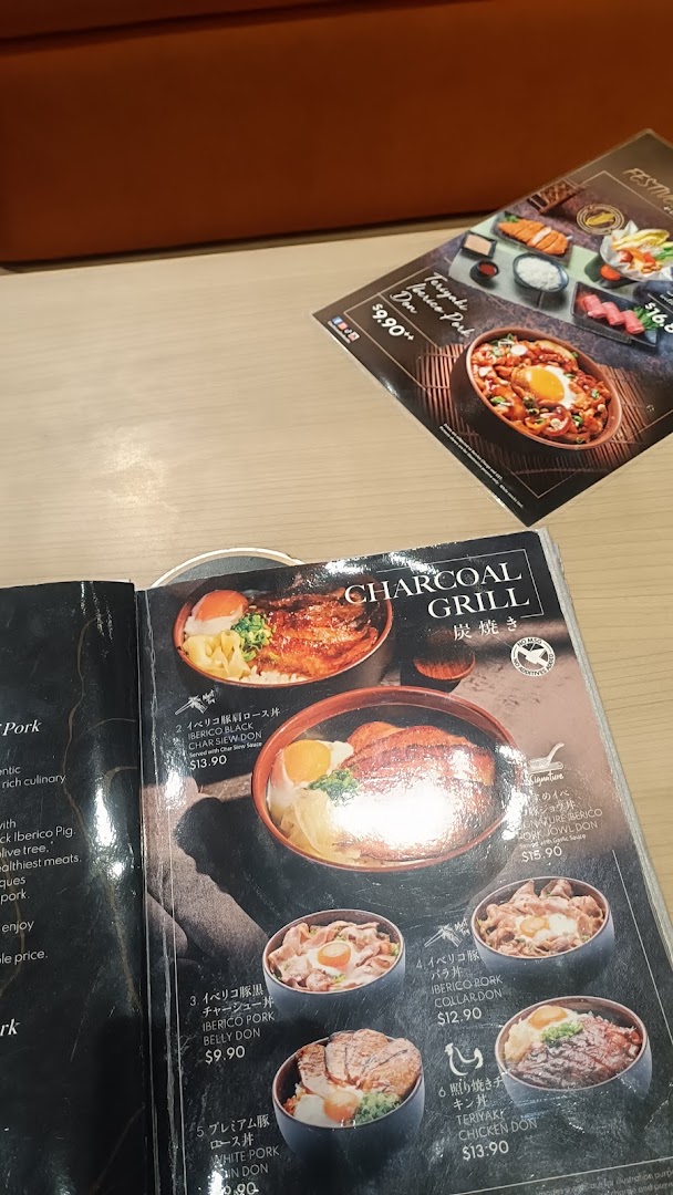 A close-up view of a Japanese restaurant menu featuring various charcoal-grilled donburi dishes.