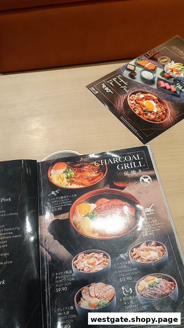 A close-up view of a Japanese restaurant menu featuring various charcoal-grilled donburi dishes.
