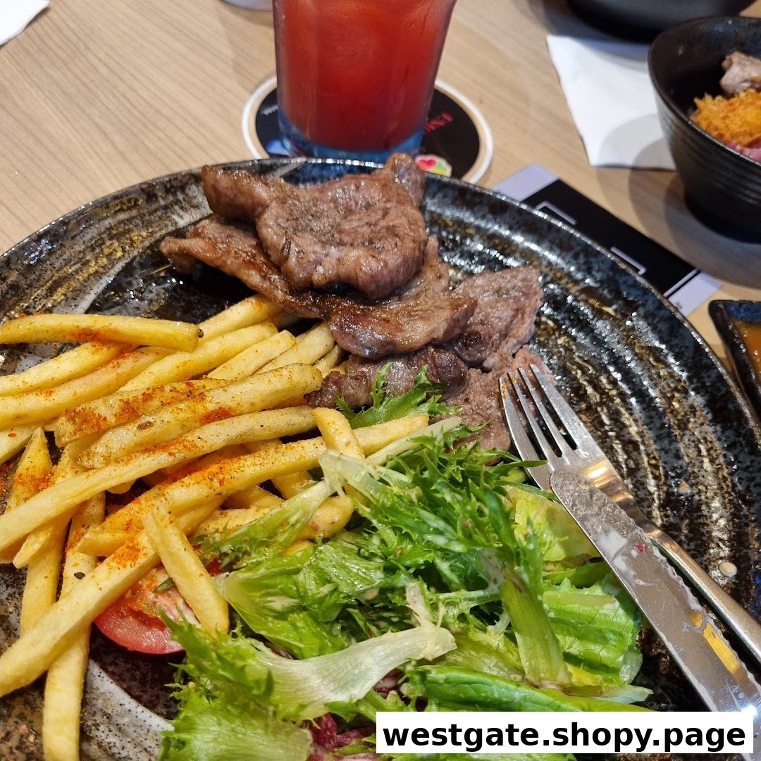 A delicious plate featuring grilled steak, crispy fries, and a fresh green salad.
