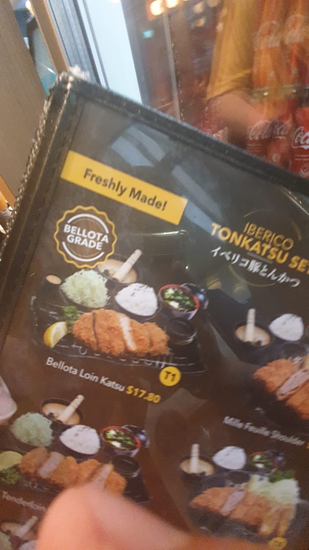 A close-up of a menu displaying premium Iberico Tonkatsu sets and prices.
