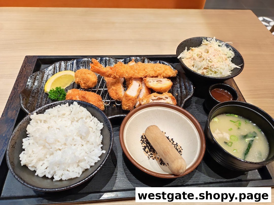 A delicious Japanese fried food set featuring tonkatsu, fried shrimp, rice, miso soup, and salad.
