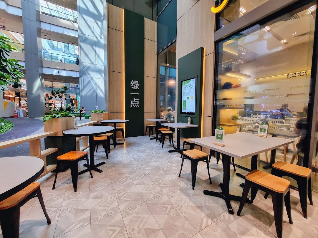Greendot Westgate shopfront with inviting outdoor seating and a glimpse of the interior.