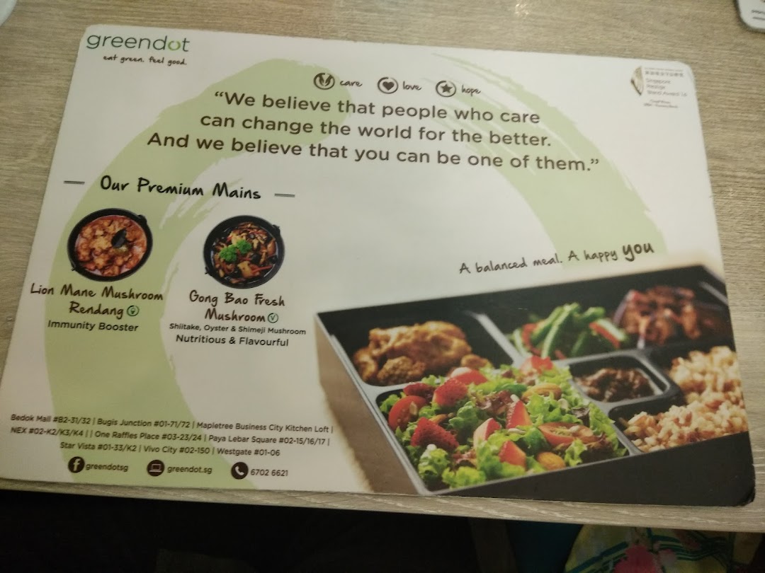 A Greendot menu placemat showcasing premium mushroom mains and the brand's healthy eating philosophy.