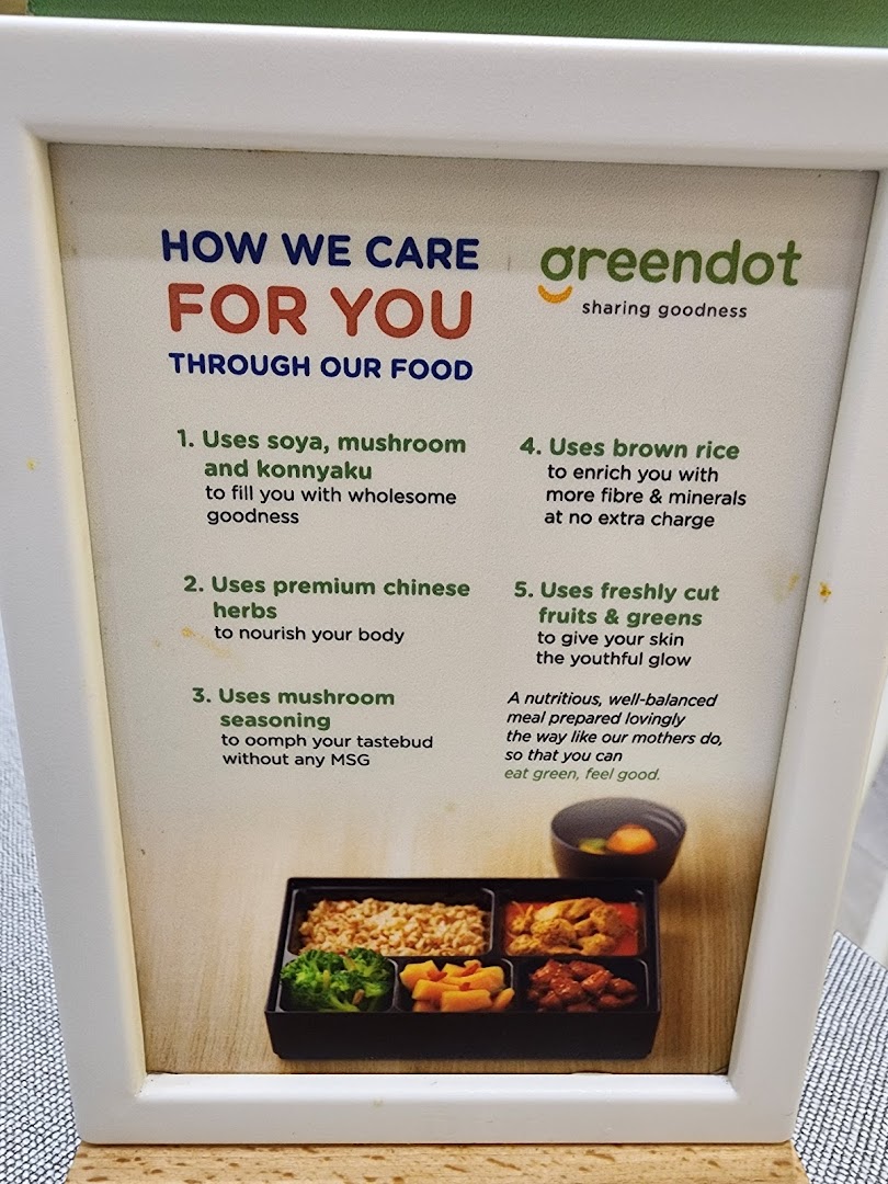 A Greendot sign detailing their healthy food philosophy with an image of a bento box.