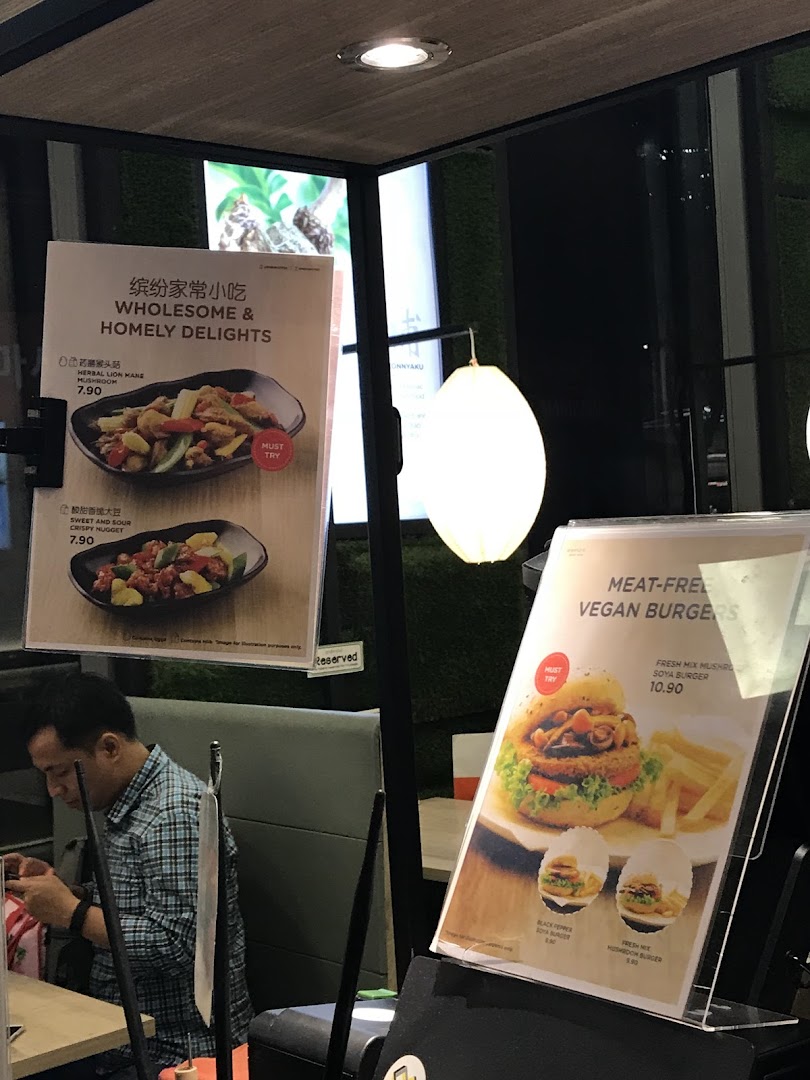 Two menu displays showcasing Greendot's wholesome vegan dishes and meat-free burgers.
