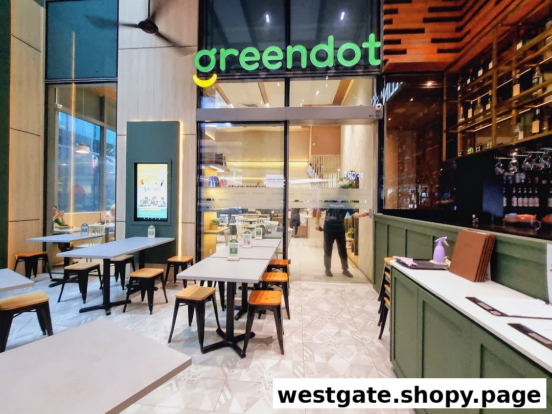 The exterior of Greendot Westgate features outdoor seating and a clear view into the modern vegetarian restaurant.