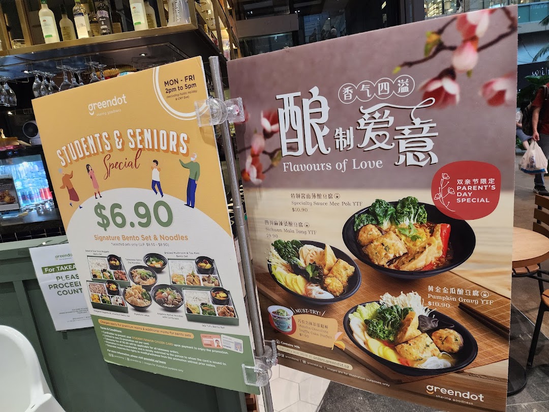 Two promotional boards at Greendot showcasing special meal deals and new menu items.