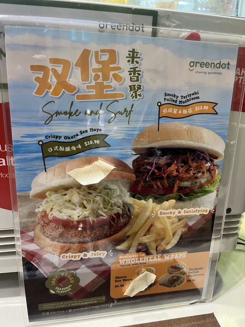 A promotional menu display showcasing Greendot's vegan burgers and wraps.