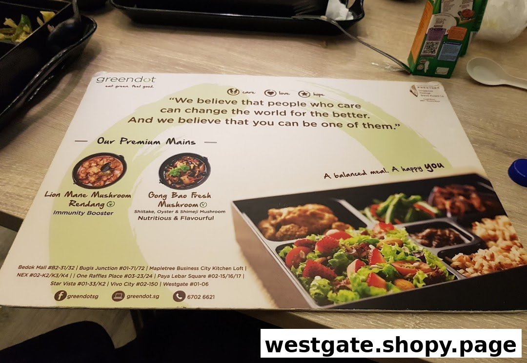 A Greendot placemat showcasing premium plant-based mains, a bento box, and the brand's philosophy.