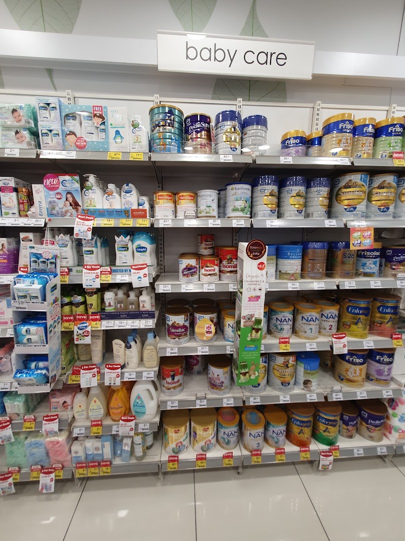 An aisle in Guardian Health & Beauty featuring a wide range of baby care products and infant formula.