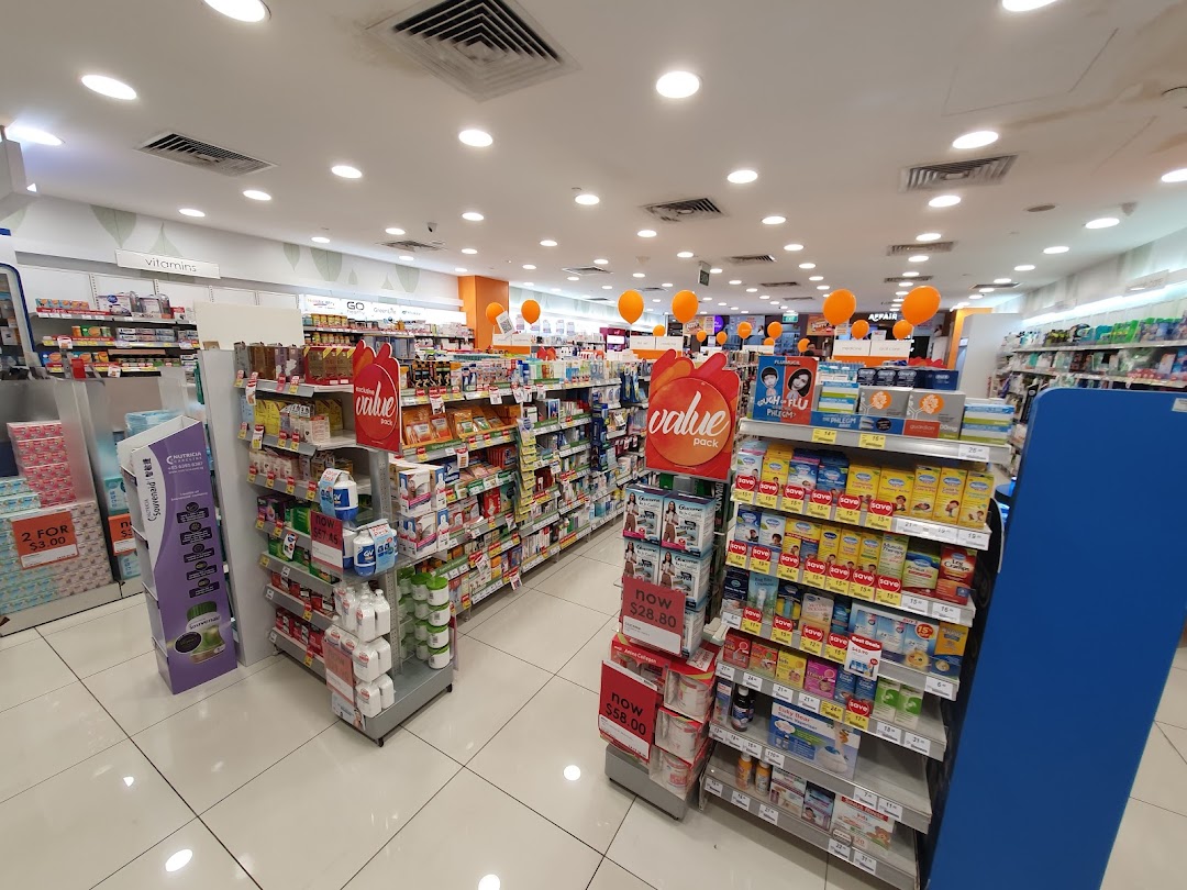 An interior view of a Guardian Health & Beauty store aisle, showcasing various health and beauty products.