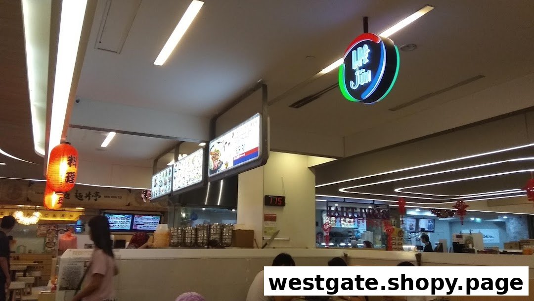 An interior view of Ha-Jun Westgate, showing diners, menu displays, and the shop's vibrant sign.