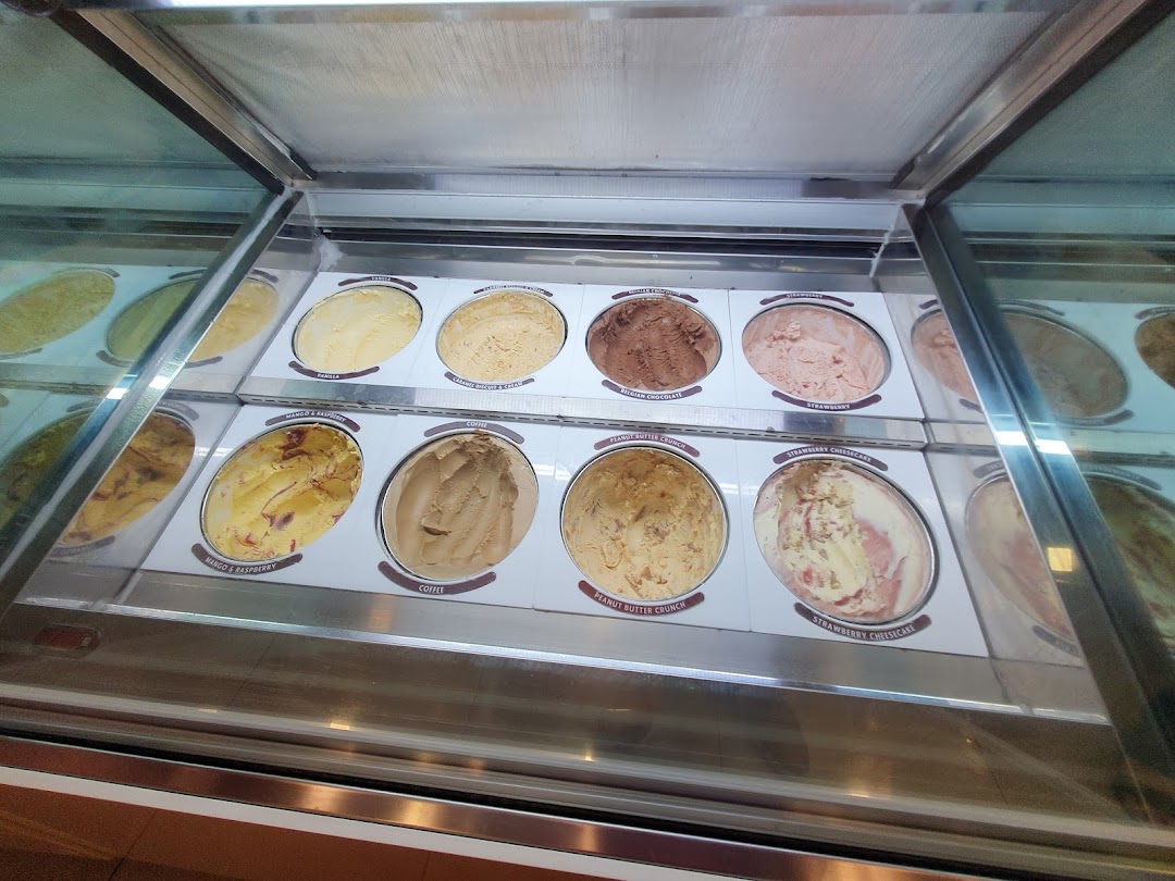 A vibrant display of various Häagen-Dazs ice cream flavors in a freezer.