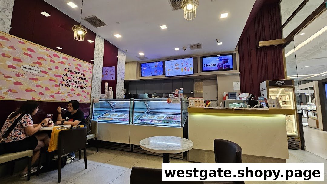 Interior view of a Häagen-Dazs ice cream shop with customers enjoying treats and display freezers.