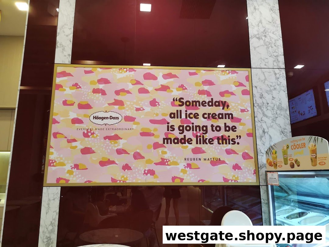 An interior view of Häagen-Dazs featuring a large marketing poster and ice cream display.