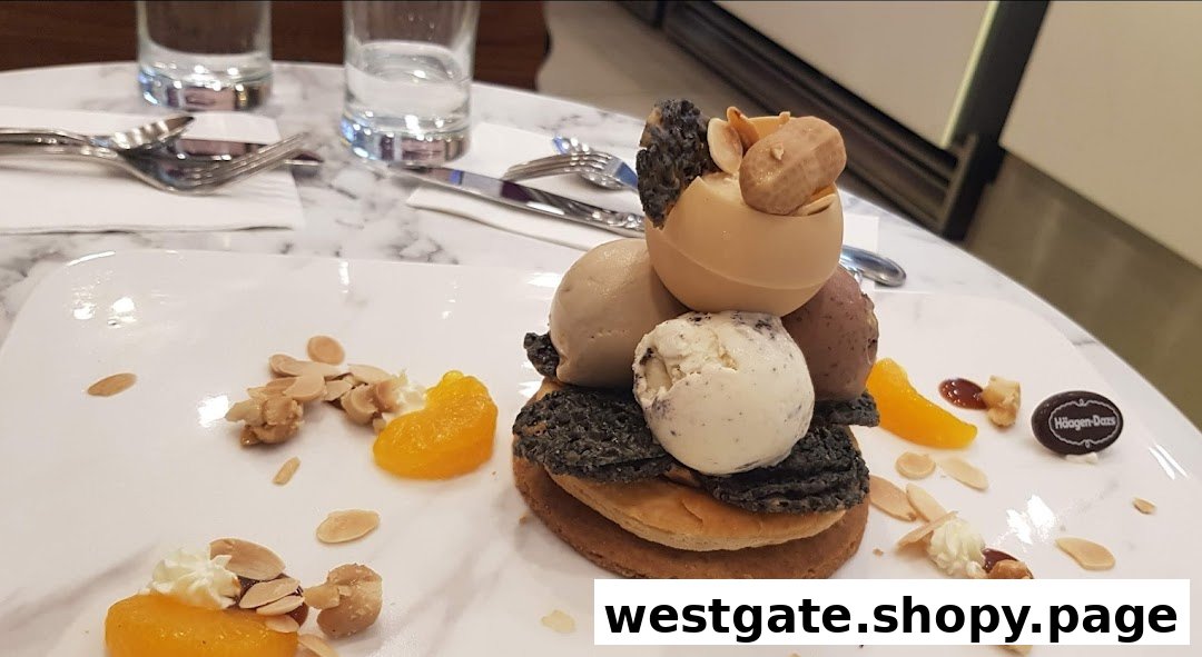 A beautifully plated Häagen-Dazs ice cream dessert with various toppings on a marble table.