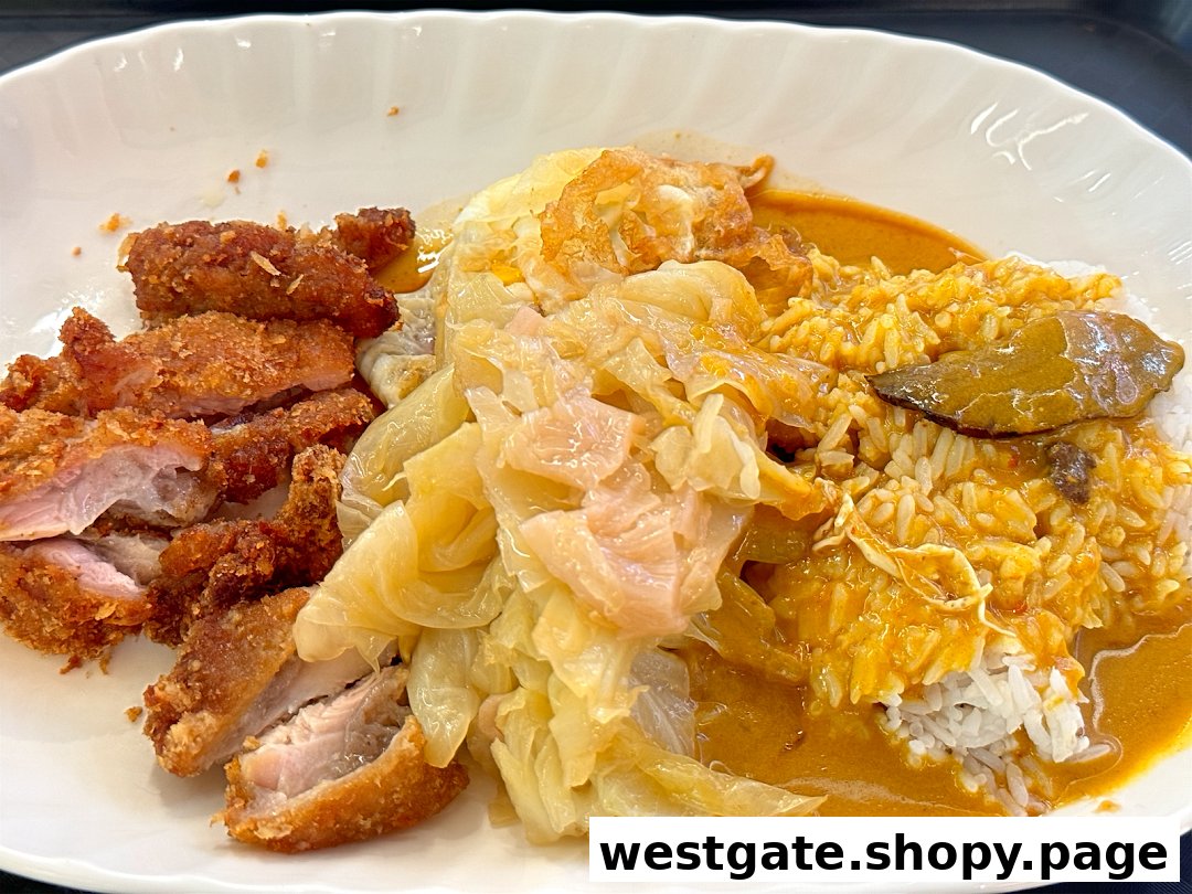 A close-up of Hainanese curry rice with crispy fried pork cutlet, braised cabbage, and a fried egg.