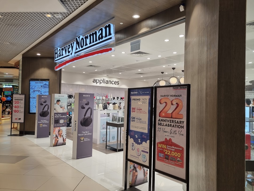 The entrance of Harvey Norman at Westgate Mall, featuring electronics and appliance displays with ongoing promotions.