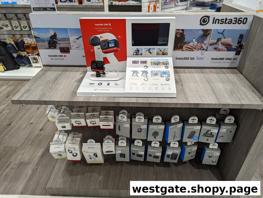 Insta360 camera display with demo unit and various accessories on a retail shelf.