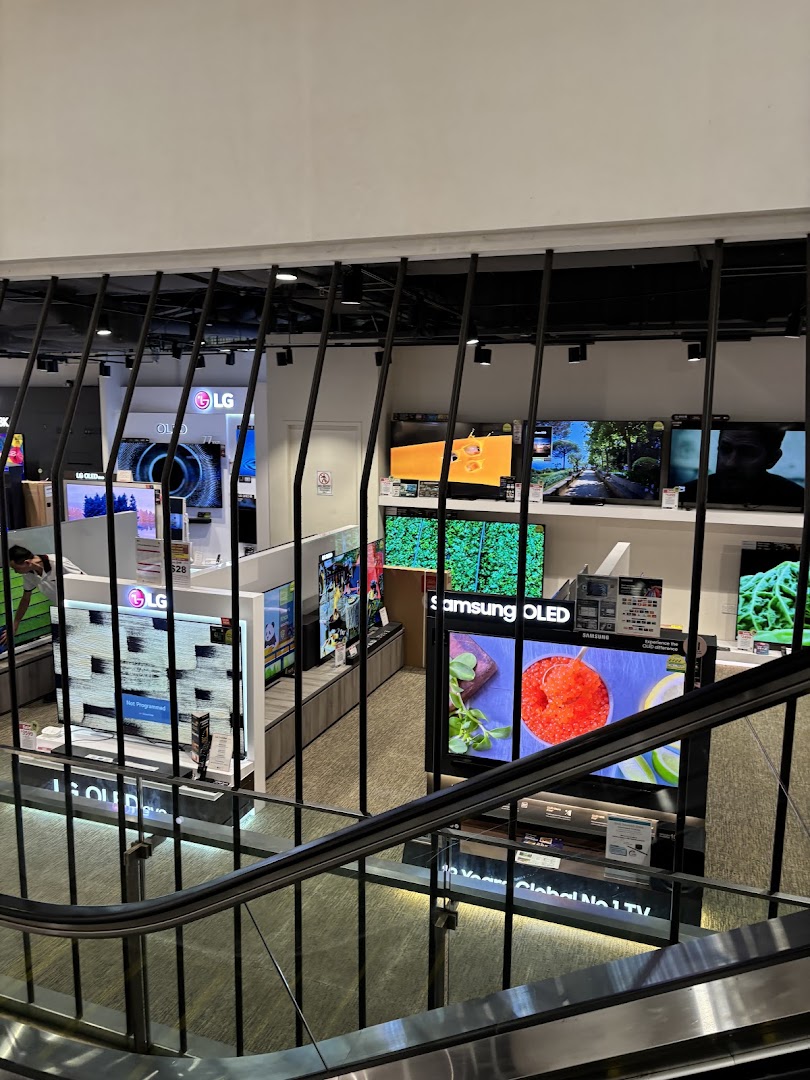 An overhead view of the electronics section at Harvey Norman, showcasing numerous LG and Samsung TVs.